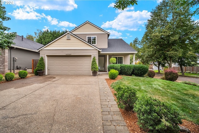 view of front of property with a garage and a front lawn