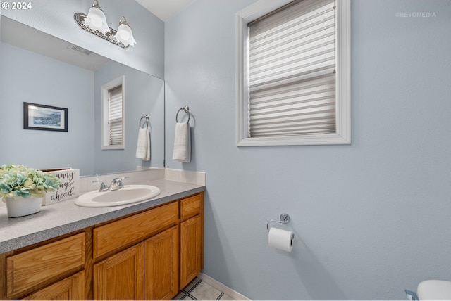 bathroom featuring tile patterned flooring and vanity