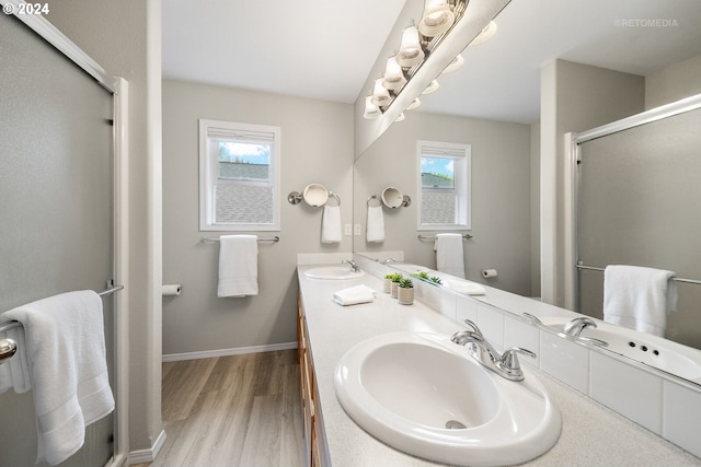 bathroom featuring a shower with door, vanity, and hardwood / wood-style flooring