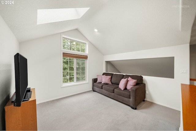 living room featuring light colored carpet and lofted ceiling with skylight