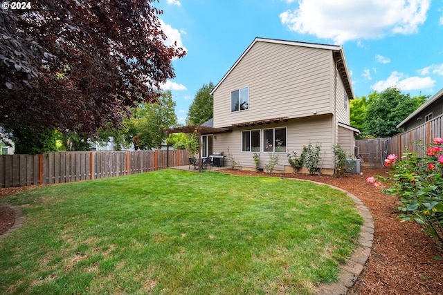 back of house featuring a yard, a patio area, and central AC