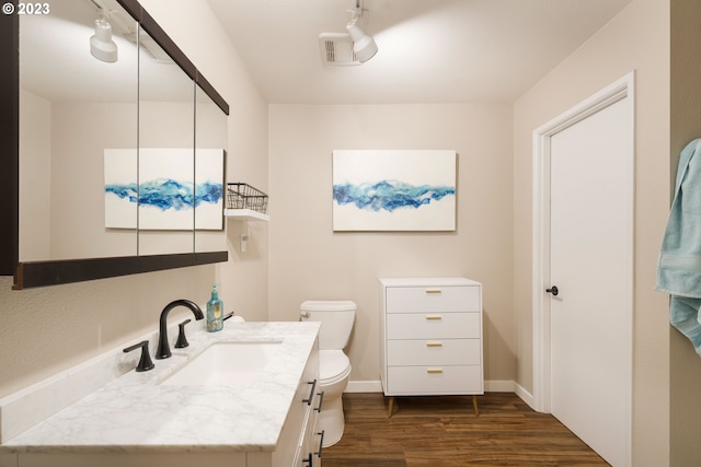 bathroom featuring hardwood / wood-style floors, vanity, and toilet