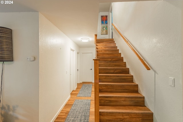 stairs with hardwood / wood-style flooring