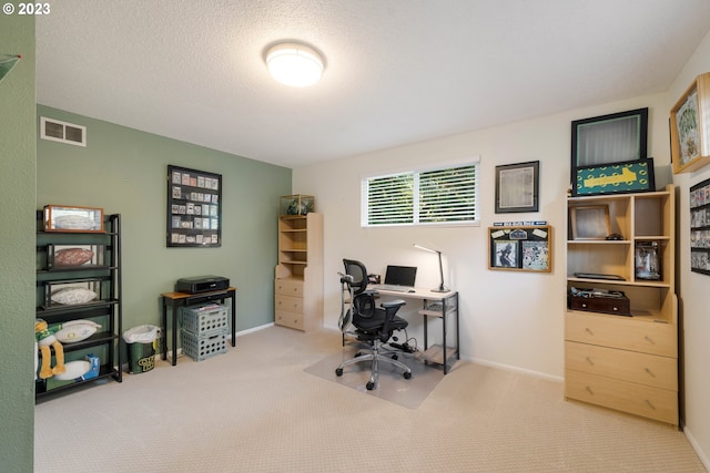 carpeted office with a textured ceiling