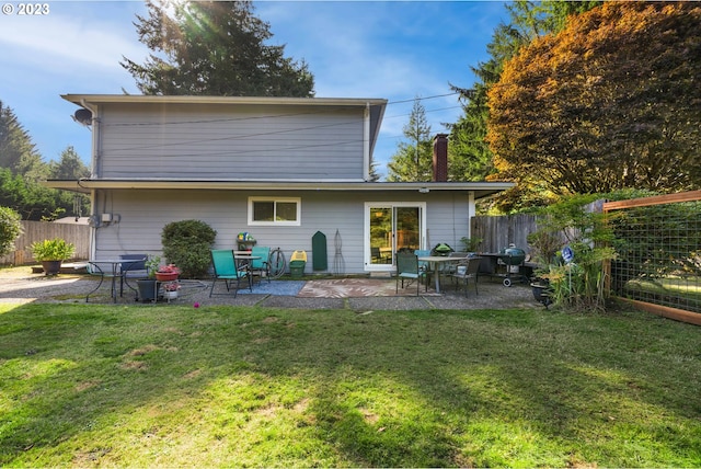 back of property featuring a yard and a patio area