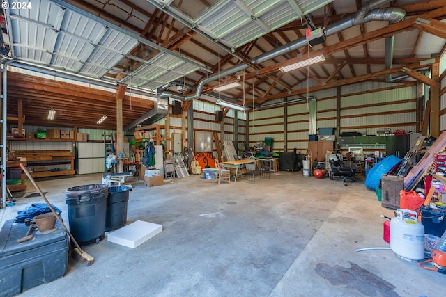 garage with white refrigerator and a workshop area