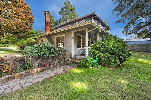 exterior space with a porch and a lawn