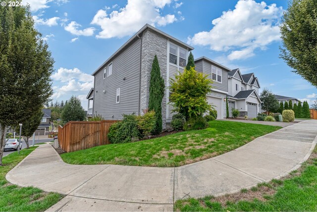 front of property featuring a garage and a front lawn