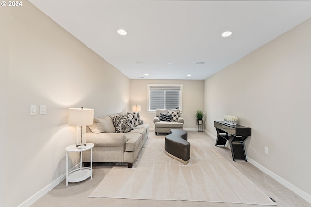 living room featuring light carpet, baseboards, and recessed lighting