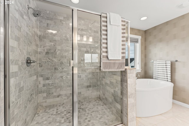 full bath featuring recessed lighting, a soaking tub, a shower stall, and tile patterned floors