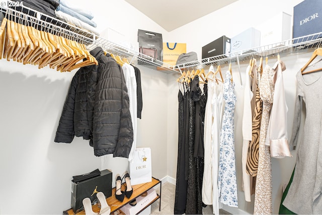 walk in closet with lofted ceiling