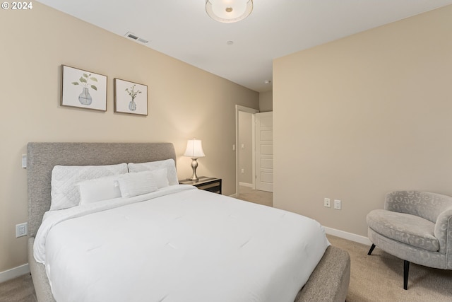 bedroom with light colored carpet, visible vents, and baseboards