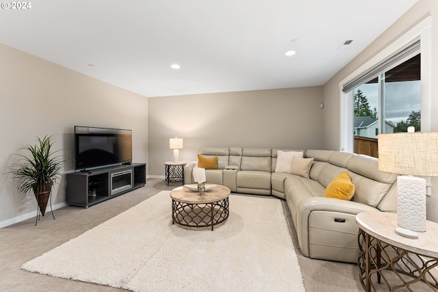 living room featuring recessed lighting, baseboards, and light colored carpet