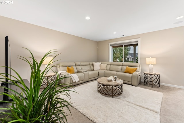 living room with recessed lighting, light colored carpet, and baseboards