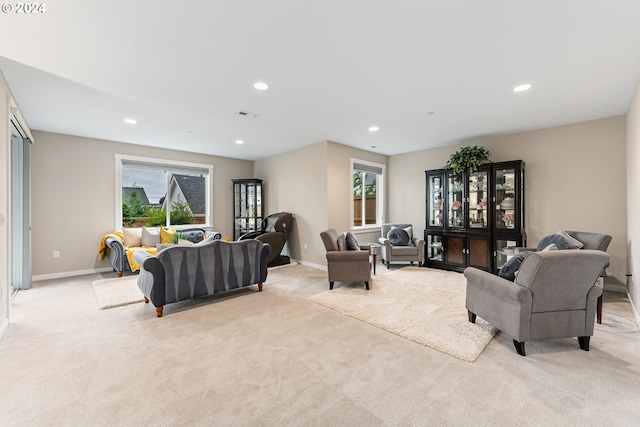 living room with light carpet, visible vents, baseboards, and recessed lighting