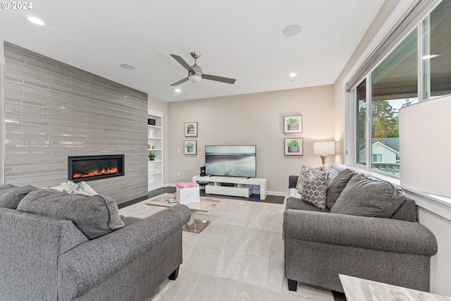 living area with built in features, recessed lighting, a fireplace, and baseboards