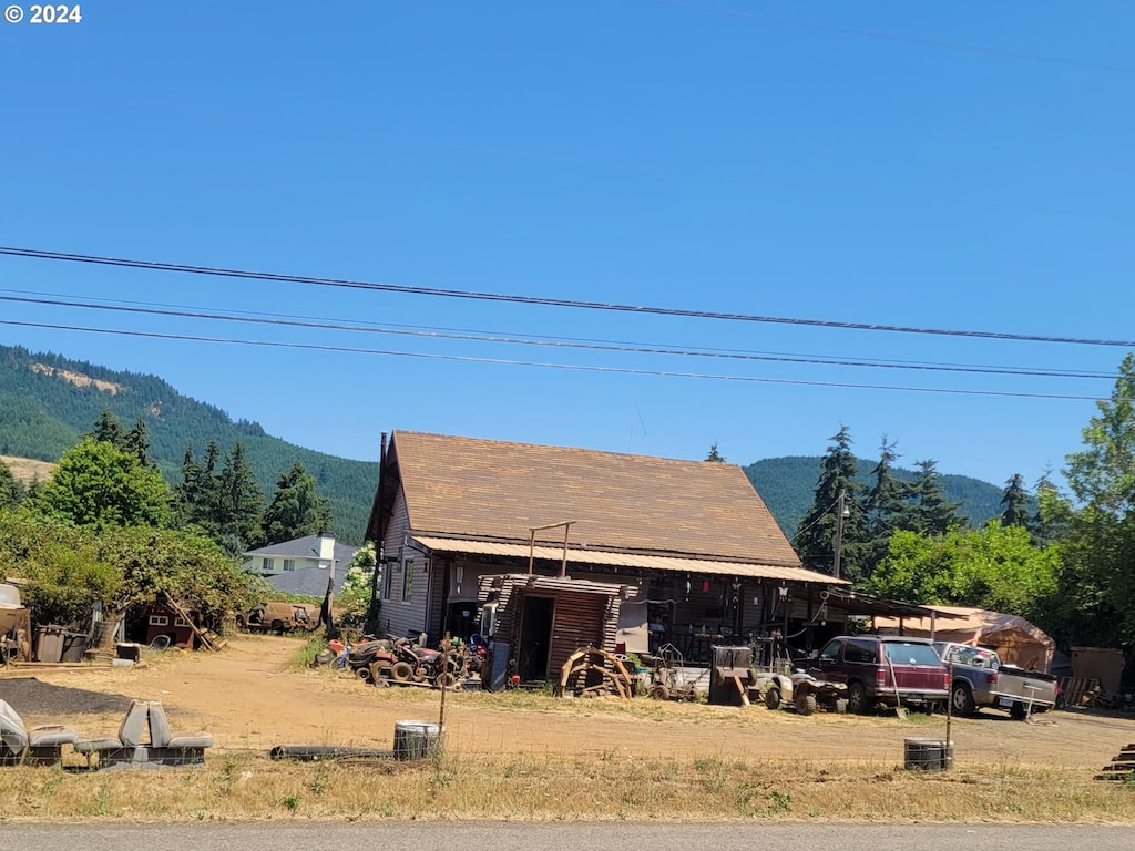 view of front of home featuring a mountain view and a carport