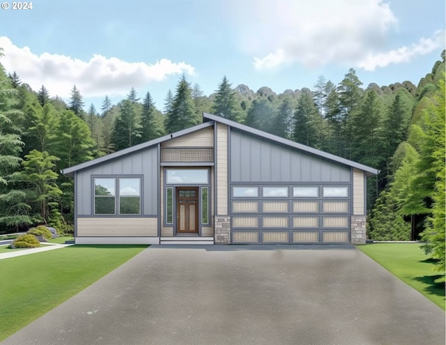 view of front of home with a front yard and a garage