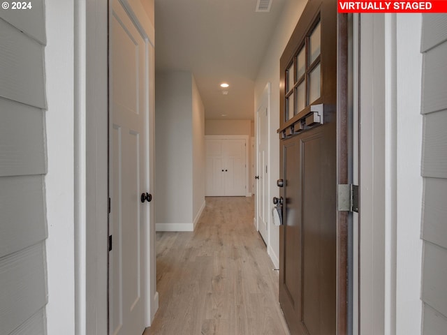 hall with light hardwood / wood-style flooring