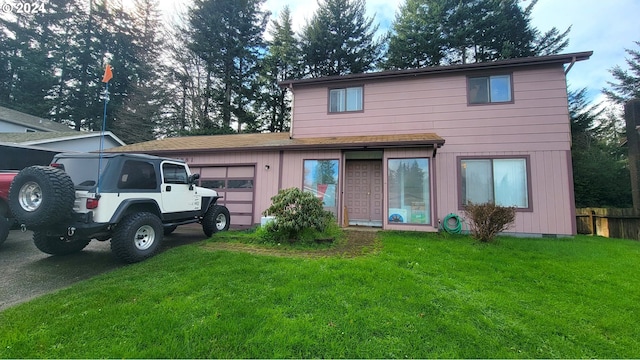 view of front of home with a front lawn and a garage