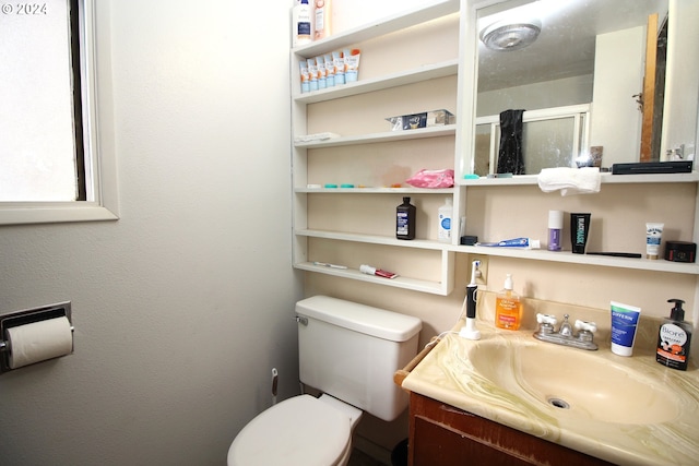 bathroom featuring toilet and vanity