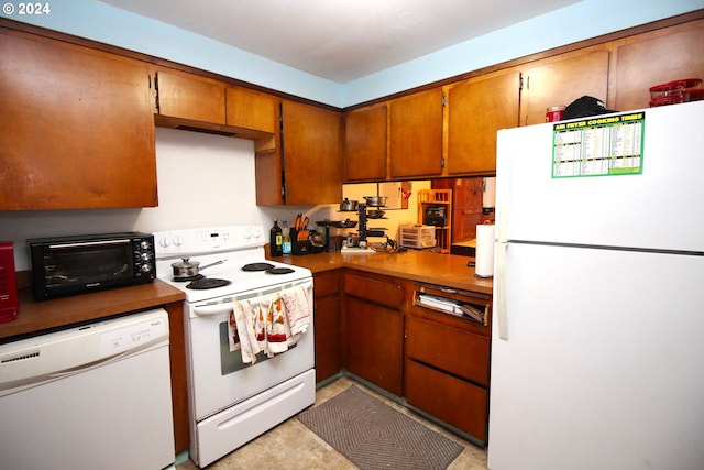 kitchen with light tile floors and white appliances