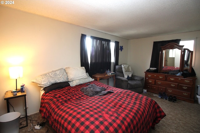 carpeted bedroom with a textured ceiling