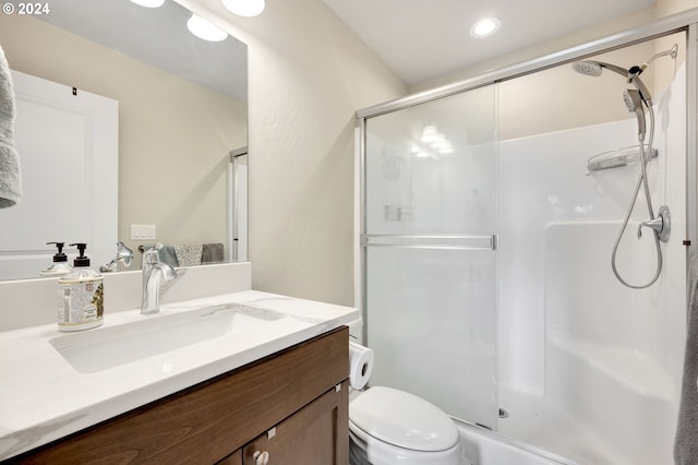 bathroom with vanity, toilet, and an enclosed shower