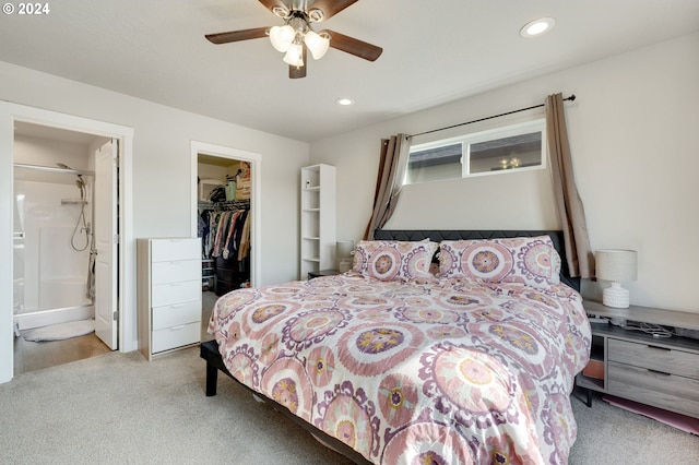 carpeted bedroom featuring ceiling fan, a walk in closet, connected bathroom, and a closet