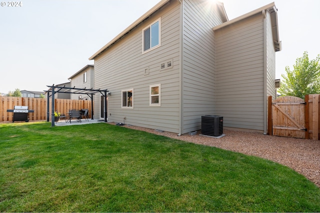 back of property with a lawn, cooling unit, a pergola, and a patio