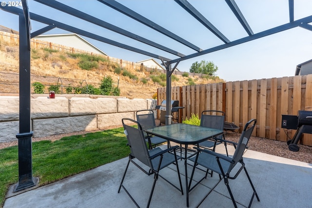 view of patio with a grill and a pergola