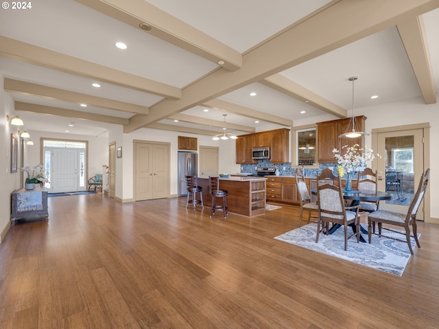 dining area with light hardwood / wood-style floors and beam ceiling