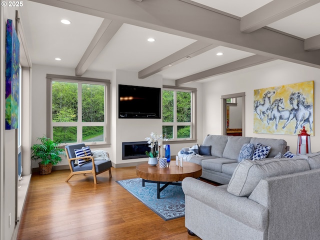 32227 Seascape Ln, Cannon Beach, OR 97110 - living room featuring beamed ceiling, wood finished floors, recessed lighting, a glass covered fireplace, and baseboards
