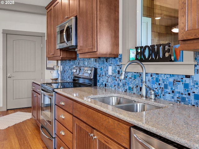 32227 Seascape Ln, Cannon Beach, OR 97110 - kitchen featuring stainless steel appliances, brown cabinets, a sink, and wood finished floors