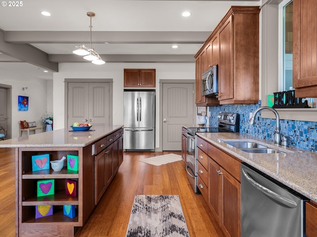 32227 Seascape Ln, Cannon Beach, OR 97110 - kitchen with appliances with stainless steel finishes, a sink, light wood-style flooring, open shelves, and tasteful backsplash