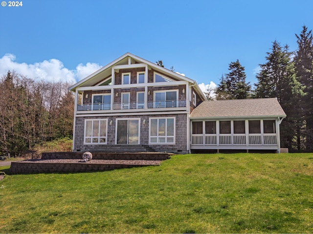 back of property with a balcony and a yard