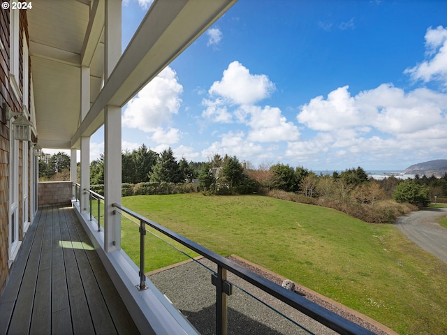 wooden deck with a lawn