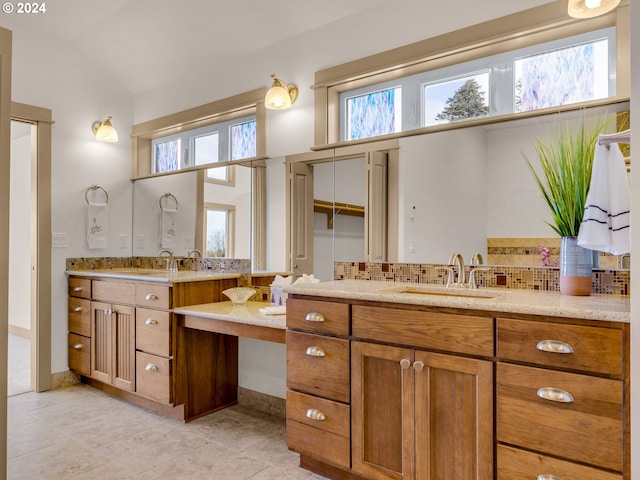 bathroom with backsplash, vanity, and tile floors