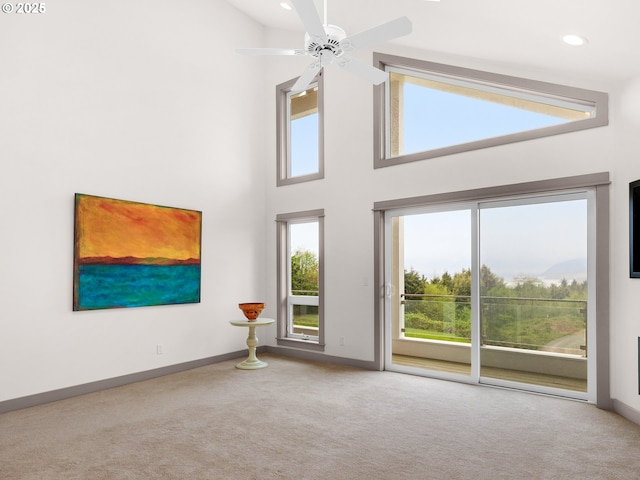 32227 Seascape Ln, Cannon Beach, OR 97110 - carpeted spare room featuring baseboards, ceiling fan, a high ceiling, and recessed lighting