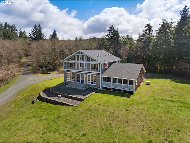 32227 Seascape Ln, Cannon Beach, OR 97110 - back of house with a sunroom, a lawn, and dirt driveway