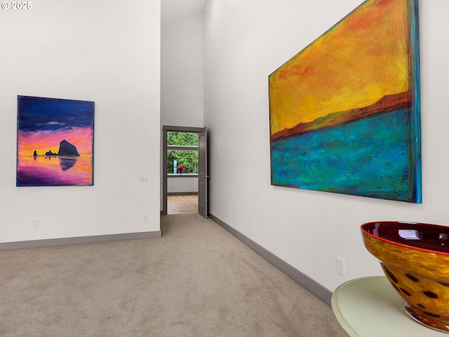 32227 Seascape Ln, Cannon Beach, OR 97110 - empty room featuring carpet, baseboards, and a high ceiling