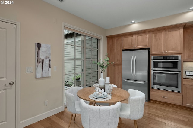 dining space with light hardwood / wood-style floors