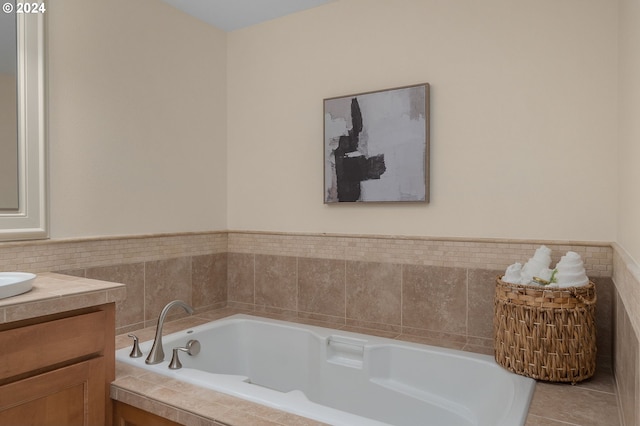 bathroom featuring tile patterned floors, a tub, and vanity