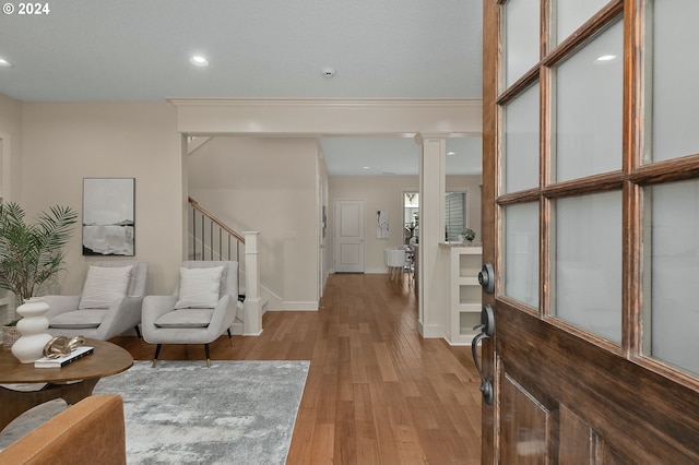 entrance foyer with light wood-type flooring and decorative columns