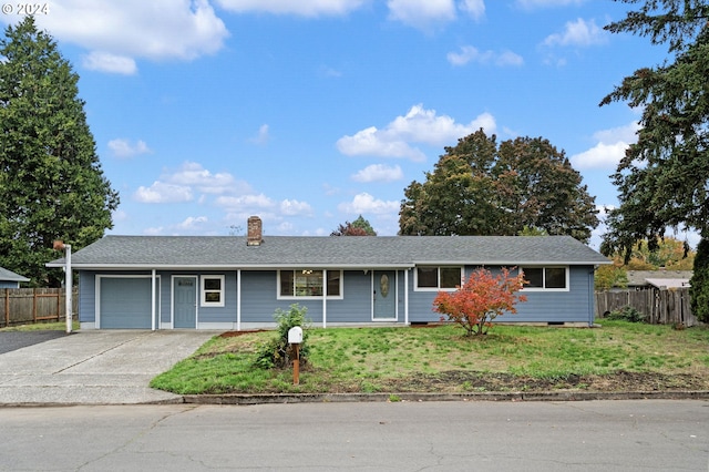 ranch-style home with a garage and a front lawn