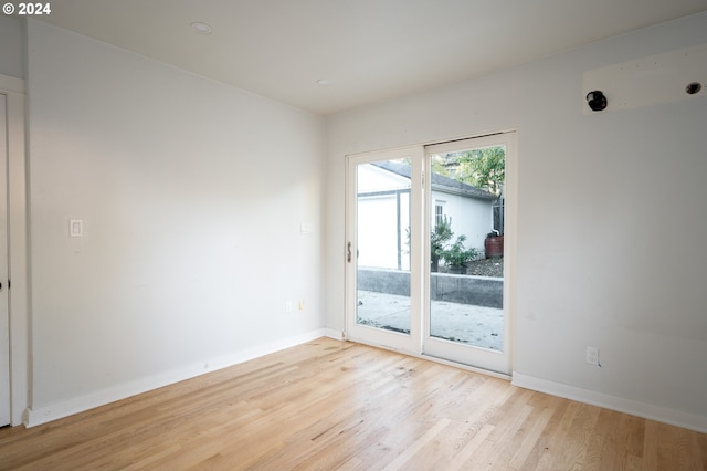 spare room featuring light wood-type flooring