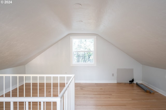 bonus room featuring hardwood / wood-style floors and vaulted ceiling