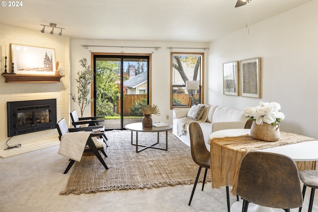 16354 SW 130th Ter Unit 76, King City, OR 97224 - living room featuring carpet flooring, ceiling fan, and a fireplace