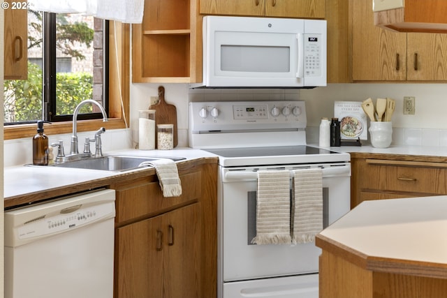 16354 SW 130th Ter Unit 76, King City, OR 97224 - kitchen with open shelves, white appliances, light countertops, brown cabinets, and a sink