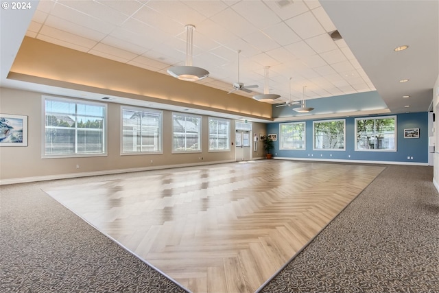 16354 SW 130th Ter Unit 76, King City, OR 97224 - interior space with baseboards, ceiling fan, plenty of natural light, and a tray ceiling